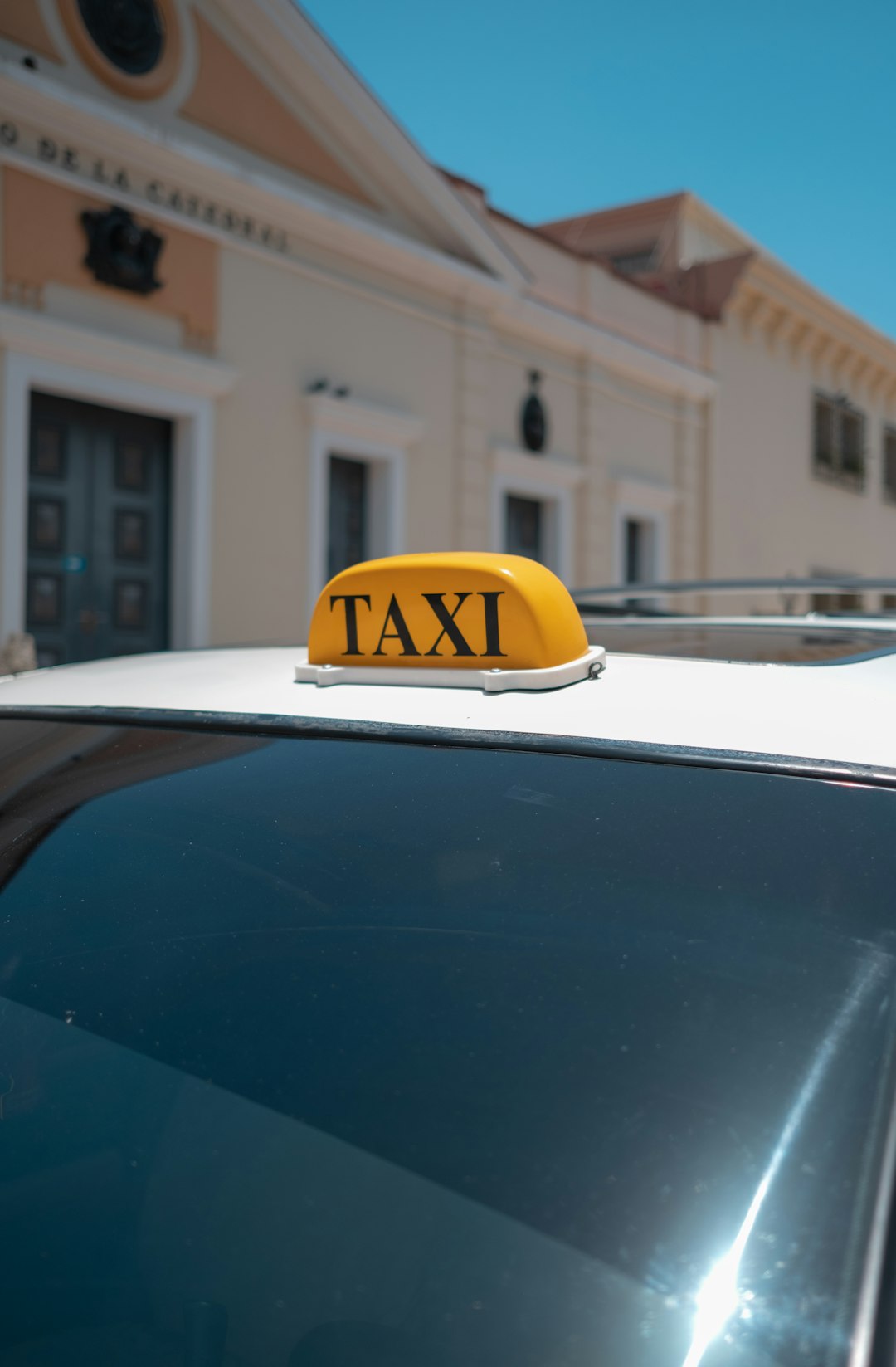 a-taxi-cab-with-a-yellow-taxi-sign-on-top-of-it-lxtafitbz5g