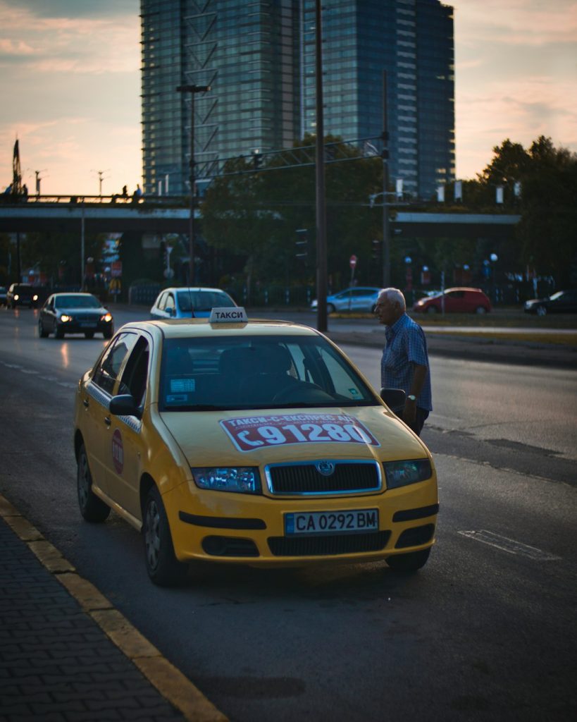 man-standing-beside-taxi-khnbja9zm-a
